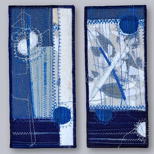 Two coordinating indigo and white embroidered textile artworks by ElinaTextileArt – minimalist fiber art duo for modern interiors.