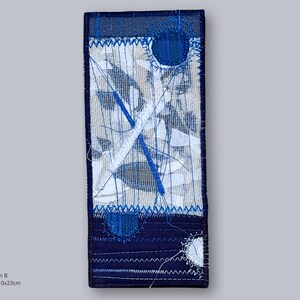 Design B – abstract embroidered artwork in indigo, white, and beige tones, handmade textile collage by Elina Lusis-Grinberga.
