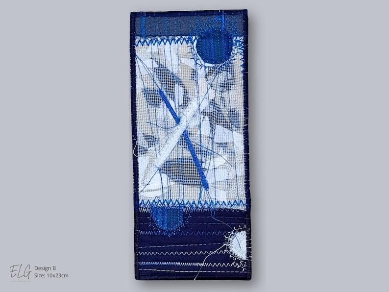 Design B – abstract embroidered artwork in indigo, white, and beige tones, handmade textile collage by Elina Lusis-Grinberga.