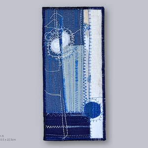 Indigo and white embroidered textile artwork – Design A by Elina Lusis-Grinberga, abstract geometric composition in layered linen and cotton textures.