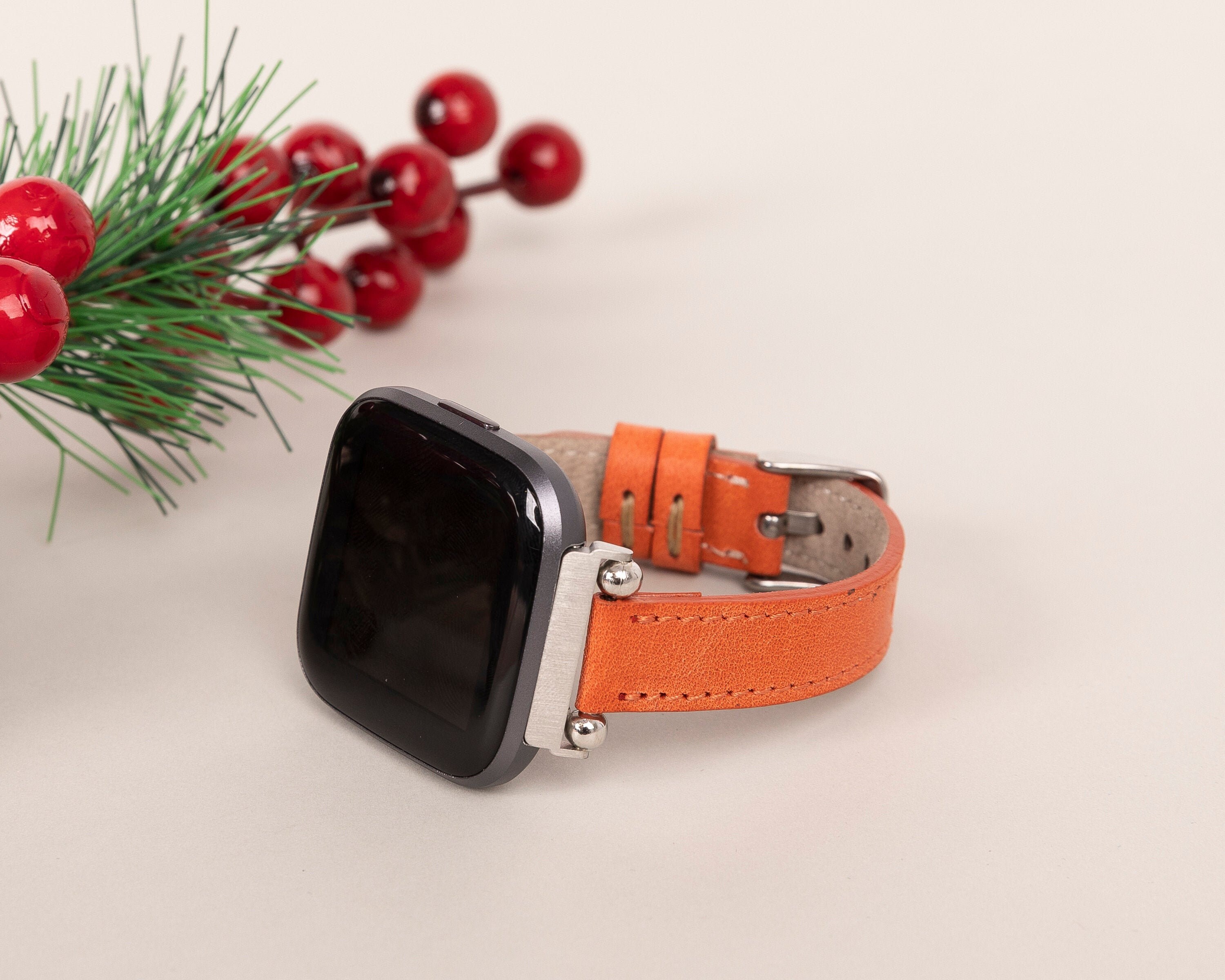 orange fitbit versa band