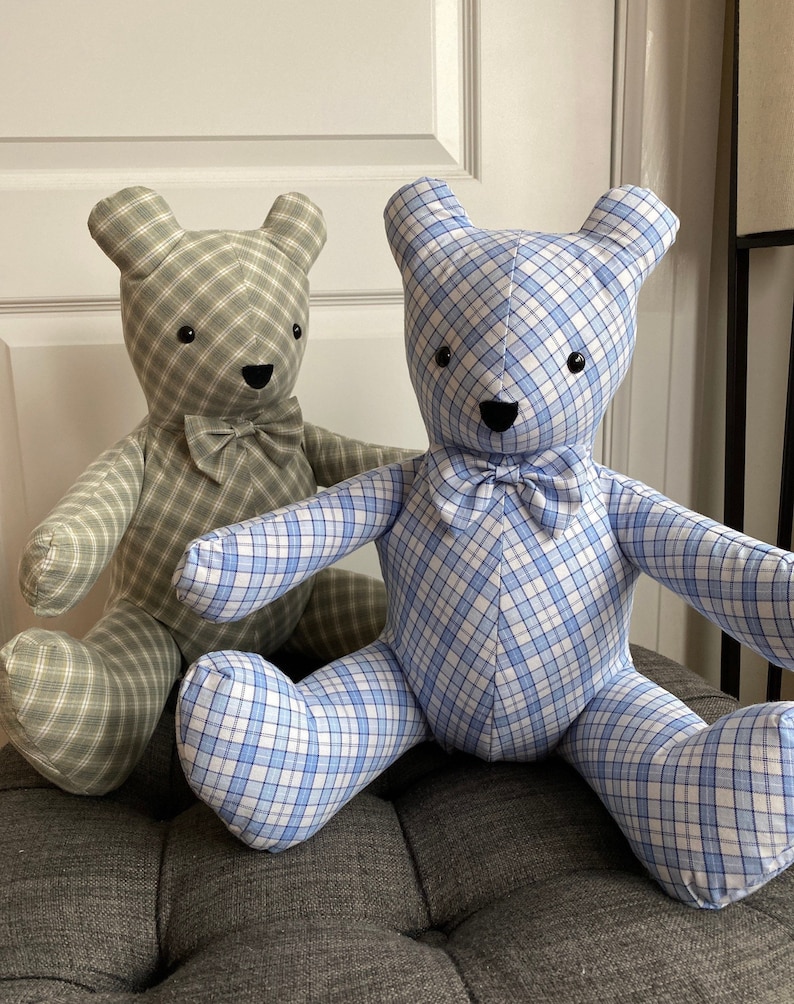 May include: Two plush teddy bears, one in a green plaid fabric and the other in a blue plaid fabric. Both bears have black eyes and a black nose, and are wearing a bow tie.