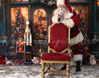 May include: Santa Claus in a red suit with white trim stands behind a red velvet chair with gold accents. He is holding his finger to his lips, as if to say 'shhh'.  A nutcracker stands in the background.