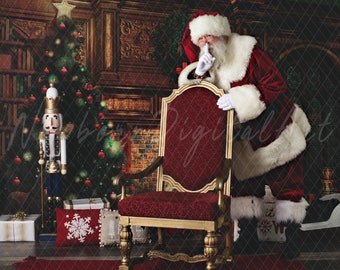 May include: Santa Claus in a red and white suit stands behind a red velvet chair with gold trim. He is holding his finger to his lips, as if to say 'shhh'. A Christmas tree and a nutcracker are in the background.