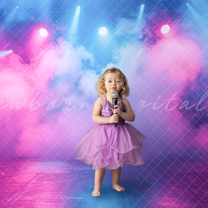 May include: A young girl in a purple dress sings into a microphone on a stage with pink and blue lights and smoke.