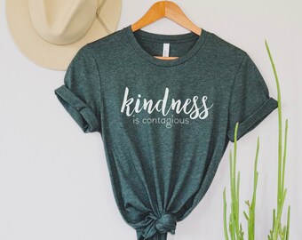 May include: A dark green t-shirt with the text "kindness is contagious" in white lettering.