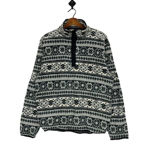 May include: A gray and black patterned fleece pullover with a mock neck and a single button closure.