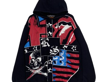 May include: Black hooded sweatshirt with a colorful graphic print featuring a skull, crossbones, stars, and the text "RS" and "Rolling Stones".