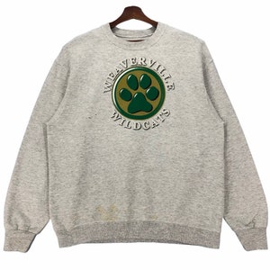 May include: Grey sweatshirt with a green paw print logo in a circle that says "Weaverville Wildcats".