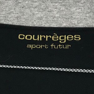 May include: A black and gold label with the text "Courr&egrave;ges sport futur" in gold lettering.