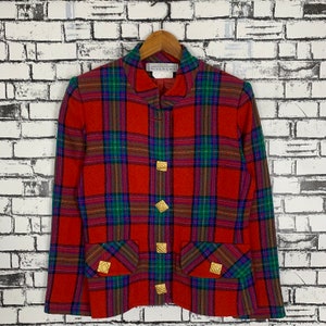 May include: Red, green and blue plaid blazer with gold buttons. The label reads "Couture Givenchy".