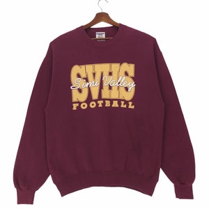 May include: Burgundy sweatshirt with a gold and white graphic that reads "SVHS Simi Valley Football".