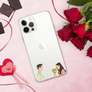 May include: A clear phone case with a white background and a printed image of a couple holding flowers. The case has a cutout for the phone's camera lenses.