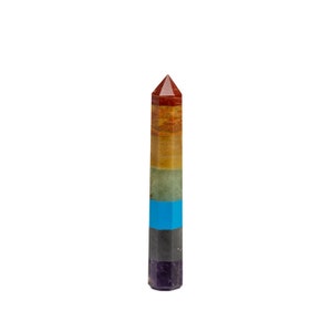 May include: A seven-chakra crystal tower with a pointed top. The tower is made of seven different colored stones, each representing a different chakra. The stones are red, orange, yellow, green, blue, indigo, and violet.