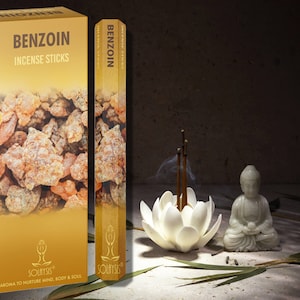 May include: A box of benzoin incense sticks with a gold background and a picture of benzoin resin. The box is labeled "Benzoin Incense Sticks" and "Aroma to Nurture Mind, Body & Soul".