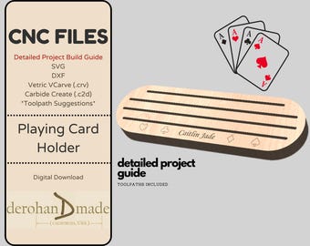 May include: A wooden playing card holder with slots for cards. The holder is engraved with the text "Caitlin Jade". The image also shows four playing cards, all aces, in the background.