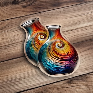 May include: Two colorful glass vases with a swirling, abstract design in shades of blue, green, yellow, orange, and red. The vases are on a wooden surface.