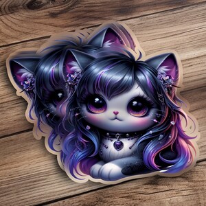 May include: Two stickers featuring a cute cartoon cat with large purple eyes, black and purple hair, and a heart-shaped pendant. The cat has a white face and a black collar. The stickers are on a wooden surface.