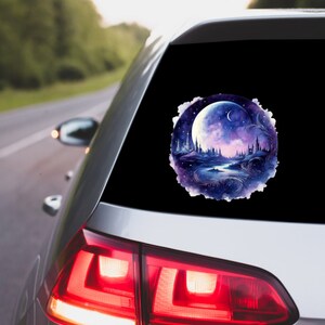 May include: A round car decal featuring a watercolor painting of a nighttime fantasy scene. The design includes a large, bright moon, a river, and silhouetted castles and trees, with a color palette of blues, purples, and white.