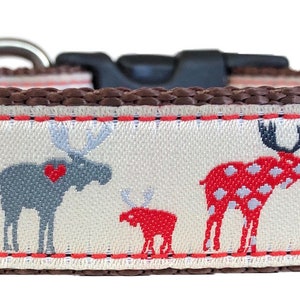 May include: A brown dog collar with a white background and a repeating pattern of red, gray, and white moose. The moose have black spots and some have red hearts.