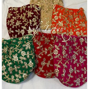 May include: Five velvet drawstring pouches with gold embroidery and sequins. The pouches are in shades of red, green, orange, pink, and beige.