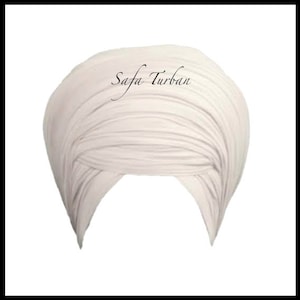 May include: A white turban, also known as a safa, is a traditional head covering worn by many cultures. The turban is made of a single piece of fabric that is wrapped around the head and tied in a knot at the back.