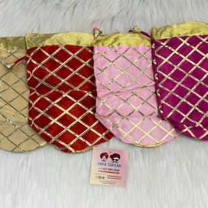 May include: Four decorative pouches with a diamond pattern. The pouches are in gold, red, pink, and purple with gold trim.