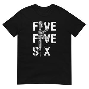 May include: Black t-shirt featuring a rifle graphic and the text "FIVE FIVE SIX" in white block letters. The design includes a detailed illustration of the firearm, centrally positioned on the shirt.