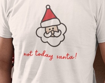 May include: A white t-shirt featuring a cartoon Santa Claus face with a red hat and the phrase "not today santa!" in red. The shirt is a festive, humorous design, perfect for the holiday season.