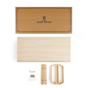 May include: A flat-pack wooden shelf kit with two shelves, two handles, and hardware for assembly. The box is brown with the logo "CRAFT KITTIES" printed on it.