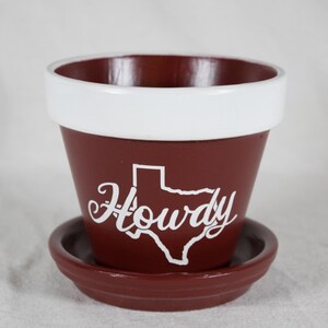 Howdy on Texas state outline, Hand Painted Terracotta Planter, 6 inch Pot with Saucer.  (P-UALB-TM6).