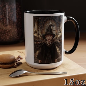 May include: White ceramic mug with a black interior and handle. The mug features a detailed illustration of a character wearing a black robe and hat. The text "15oz" is printed at the bottom of the mug.