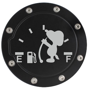 May include: Black circular fuel door cover with a gray Snoopy graphic holding a gas pump nozzle. The cover has the letters "E" and "F" on either side of a gas pump icon, and is secured with silver rivets.