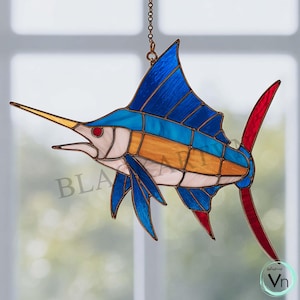 May include: Stained glass swordfish suncatcher with blue, orange, white, and red accents. The fish has a long, yellow beak and is suspended by a chain. The design features a detailed, colorful depiction of a swordfish, perfect for nautical decor.