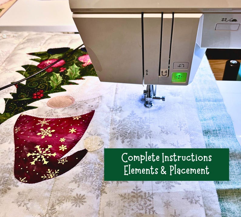 May include: A close-up of a sewing machine stitching a quilt with a Christmas theme. The quilt features a red and white Santa hat with snowflakes, a green holly sprig, and a white background with snowflakes. The text "Complete Instructions Elements & Placement" is visible in the image.