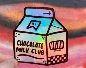 Könnte beinhalten: Ein holografischer Aufkleber in Form eines Milchkartons mit dem Text "CHOCOLATE MILK CLUB" und einem Barcode mit der Nummer "10061021".