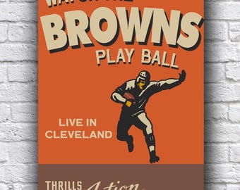 May include: A vintage-style poster with an orange background and brown accents. The poster features a football player in action, with the text "Watch the Browns Play Ball" in large, bold letters. The poster also includes the text "Live in Cleveland" and "Thrills Action Entertainment!"