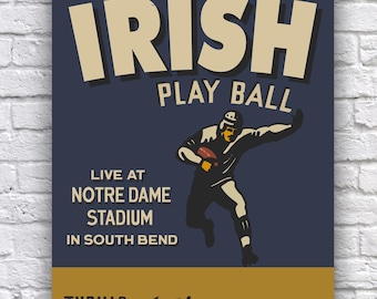 May include: A vintage-style poster advertising a football game. The poster features a blue background with the text "WATCH THE IRISH PLAY BALL" in white and yellow lettering. The poster also features a drawing of a football player in a black and white uniform, running with the ball. The text "LIVE AT NOTRE DAME STADIUM IN SOUTH BEND" is also included on the poster. The bottom of the poster features a yellow background with the text "THRILLS Action ENTERTAINMENT!" in black lettering.