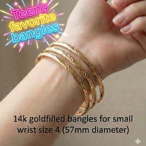 May include: Four gold-filled bangles with a textured leaf design are stacked on a wrist. The text reads "Teens favorite bangles" and "14k goldfilled bangles for small wrist size 4 (5.7cm diameter)".