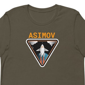 May include: A dark green t-shirt with a white triangle graphic featuring a rocket ship in space. The triangle has an orange border and the text "ASIMOV" in orange letters.