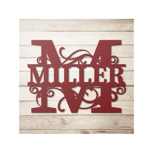 May include: A burgundy metal wall sign featuring the name "MILLER" with the initial "M" above and "IV" below. The design includes decorative flourishes and is set against a light wood background.