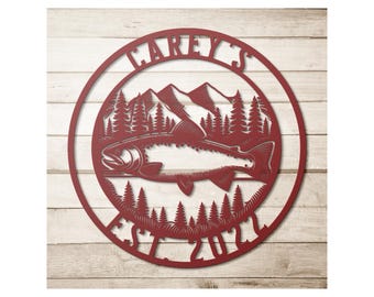 May include: A red metal wall art piece featuring a fish, mountains, and trees within a circular frame. The text "CAREY'S" arches across the top, with "EST. 2021" at the bottom. The design is cut from metal.