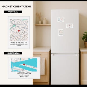 May include: A white refrigerator with three map magnets and two framed map prints. The vertical print says "Where We Met" with a heart over a map of Paris. The horizontal print says "Honeymoon" over a map.