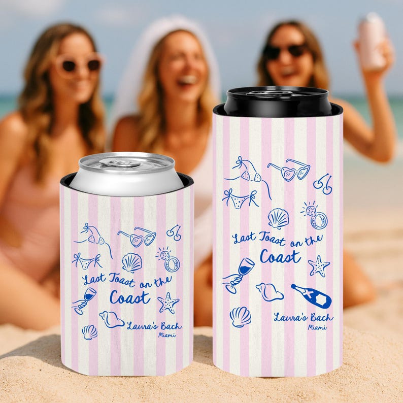 May include: Two can coolers with pink and white vertical stripes. The coolers have blue line art of beach-themed icons and the text "Last Toast on the Coast" and "Laura's Bach Miami". One cooler holds a silver can.