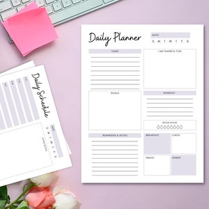 May include: A printable daily planner with sections for tasks, goals, workout, reminders and notes, water intake, breakfast, lunch, snack and dinner. The planner also includes a section for daily gratitude.