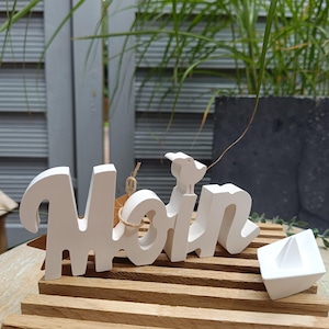 Lettering &quot;Moin&quot; and small boat