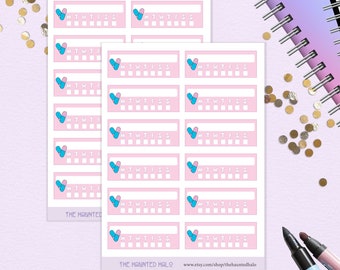 May include: A sheet of pink and white planner stickers with a pill-shaped heart design. The stickers feature the days of the week, Monday through Sunday, and have blank spaces for marking tasks or appointments. The stickers are labeled "THE HAUNTED HALO" and include a website address.