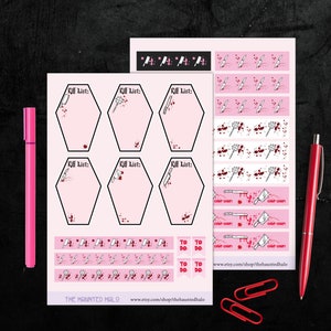 May include: A set of pink and white planner stickers featuring a bloody knife and the text "Kill List". The stickers include to-do lists, banners, and decorative elements. The stickers are designed for use in a planner or journal.
