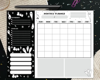 May include: A black and white Halloween-themed planner and to-do list. The planner has a monthly calendar layout. The to-do list features the word "Boo" and ghost illustrations. A pair of glasses, a pen, and a paperclip are also in the image.