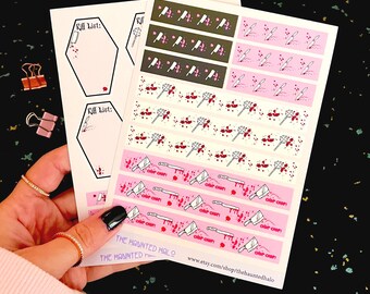 May include: A hand holds several sheets of stickers with a spooky theme. The stickers feature coffin shapes with "Kill List" text, and repeating patterns of knives, cleavers, and blood splatters in pink, white, and black. The Haunted Halo Etsy shop is visible.